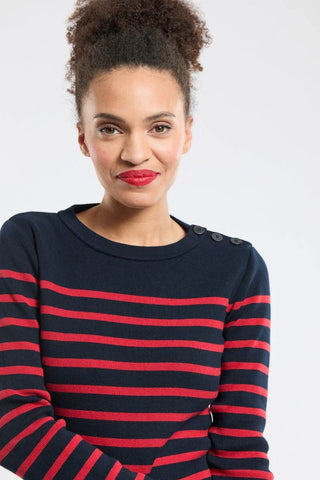 Woman wearing a navy and red striped knit sweater with button detail on shoulder