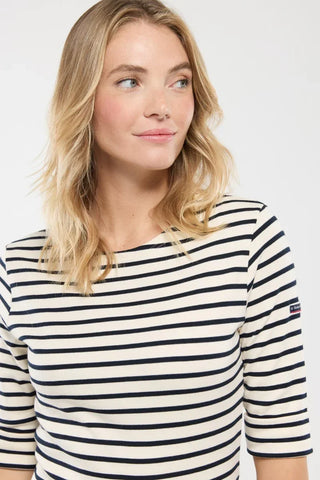Woman wearing a navy and white striped boat neck shirt, casual style, short sleeves