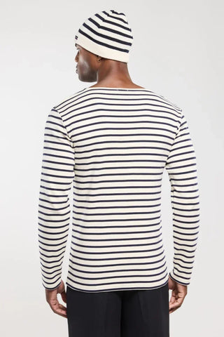 Man wearing long sleeve navy and white striped shirt and matching beanie, back view