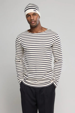 Man wearing a navy and white striped long sleeve shirt and matching beanie, casual style
