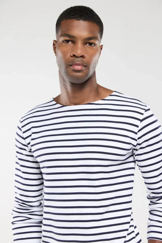 Man wearing a white and navy striped long sleeve shirt, classic Breton style.