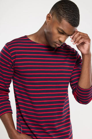Man wearing navy and red striped long sleeve shirt, casual men's fashion top.