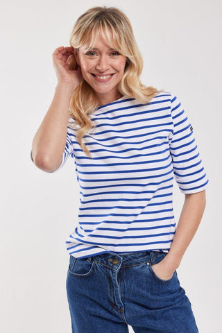 Woman wearing blue and white striped Breton shirt with three-quarter sleeves and blue jeans