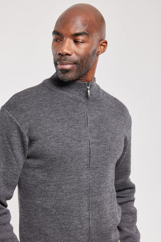 Man wearing a grey zip-up wool cardigan with a stand collar, against a plain background