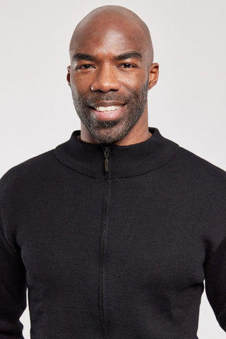 Man wearing a black zip wool cardigan with a ribbed collar, close-up on upper body