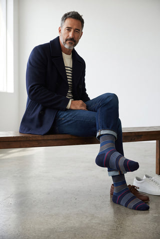 Le Capitaine D'a Bord Bugatchi striped navy cotton and cashmere socks worn by a man in a pea coat and jeans