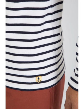 Navy and white striped cotton Breton shirt with anchor patch, paired with rust pants