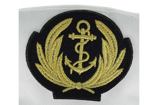 Embroidered gold anchor and laurel badge on a white captain hat