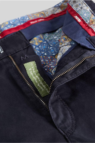 Close-up of dark blue cotton Meyer pants with zip fly and patterned waistband lining