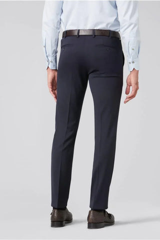 Back view of man wearing navy wool dress pants with belt and brown dress shoes