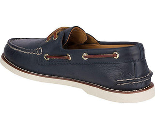 Men's navy leather boat shoe with white sole and brown lace detailing
