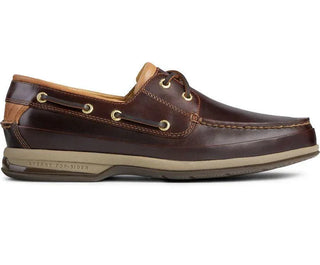 Men's brown leather boat shoe with gold eyelets and tan sole, side view